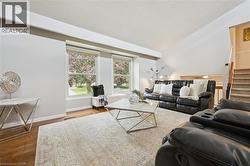 Hardwood-finish flooring, a window bench, and a carpeted staircase - 