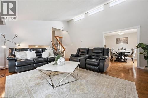 Vaulted ceilings with transom windows, wood-finish flooring, staircase with wood banister, and a distinct dining area - 21 Colebrook Court, Kitchener, ON 