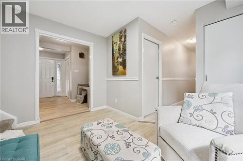 Light-colored wood-finish flooring, white trim details, and neutral wall tones - 21 Colebrook Court, Kitchener, ON 