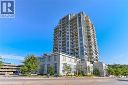 Multi-story residential building featuring a light-colored exterior and numerous private balconies - 