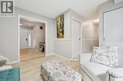 Light-colored wood-finish flooring, white trim details, and neutral wall tones - 