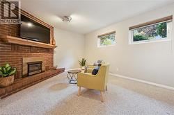 Brick-clad fireplace with a wood mantel, integrated firebox, and a hearth - 