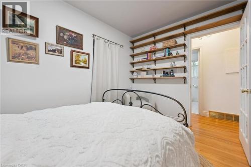 White walls with a series of built-in open wooden shelves featuring black metal brackets - 135 Bridge Street W, Waterloo, ON 
