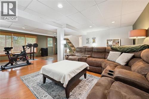 Finished lower level featuring wood-finish flooring, recessed lighting, and a drop ceiling - 135 Bridge Street W, Waterloo, ON 