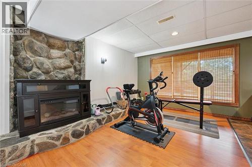 Stone-clad fireplace feature with built-in electric insert - 135 Bridge Street W, Waterloo, ON 