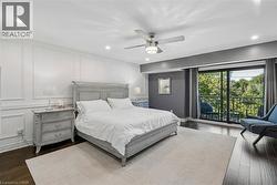 Dark wood-finish flooring with a light area rug - 