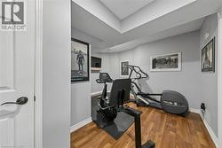 Recessed lighting, wood-finish flooring, and white trim molding create a functional interior space - 