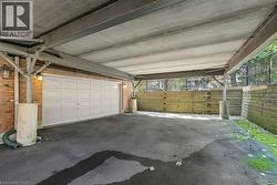 Covered parking area with concrete ceiling and structural beam supports - 