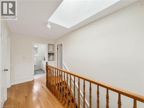 Hardwood flooring, natural wood banister, wainscoting, overhead lighting, and a skylight - 1236 Thorpe Road, Burlington, ON 