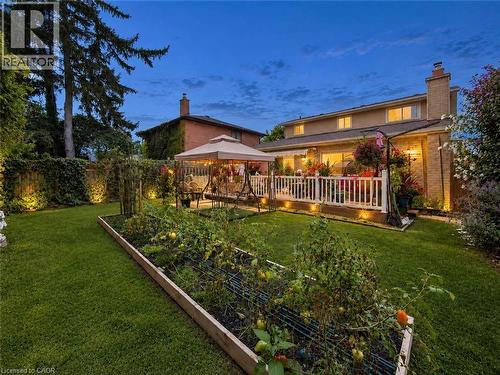Expansive green lawn featuring a raised garden bed and mature perimeter trees - 1236 Thorpe Road, Burlington, ON 