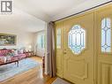 Entryway with decorative leaded glass door and sidelights, wood-finish flooring, and white walls - 1236 Thorpe Road, Burlington, ON 