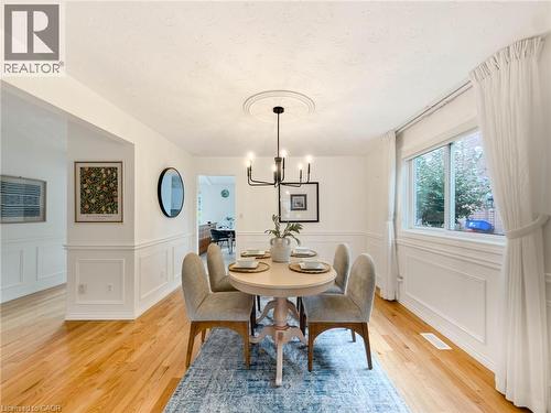 Hardwood flooring, white wainscoting, recessed window, ceiling medallion, and a six-light chandelier - 1236 Thorpe Road, Burlington, ON 