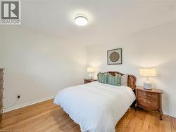 Hardwood flooring, light-toned walls, and a ceiling-mounted light fixture - 