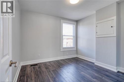 Wood-finish flooring with white trim - 23 Gibson Avenue, Hamilton, ON 