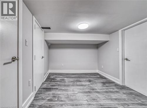 Recessed ceiling lighting, wood-finish flooring, white doors with brushed nickel hardware, and neutral wall tones - 23 Gibson Avenue, Hamilton, ON 