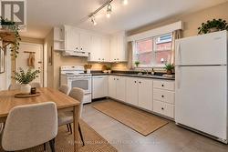 Apt 2 Main Level - Kitchen (Virtually Staged) - 