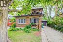 Brick facade residence featuring a front lawn, mature tree, and an attached single-car garage - 90 Brock Street, Kitchener, ON 