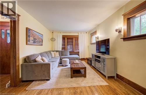 Wood-finish flooring throughout, complemented by wood trim and window frames - 90 Brock Street, Kitchener, ON 