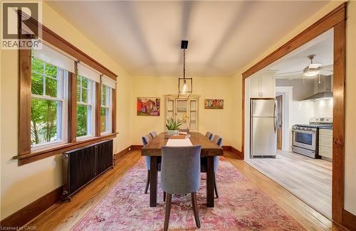 Hardwood flooring throughout, with a framed opening leading to a kitchen with stainless steel appliances - 90 Brock Street, Kitchener, ON 