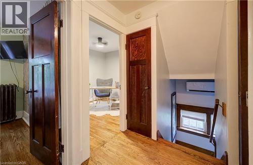 Hardwood flooring throughout, solid wood doors, and a window with wood trim - 90 Brock Street, Kitchener, ON 