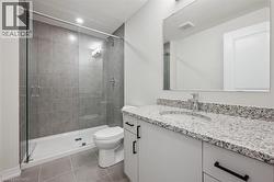 Vanity with a light-toned granite countertop and under-mount sink - 