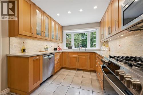 U-shaped kitchen with light wood cabinetry, a bay window, stainless steel appliances, and recessed lighting - 334 Coleridge Drive, Waterloo, ON 