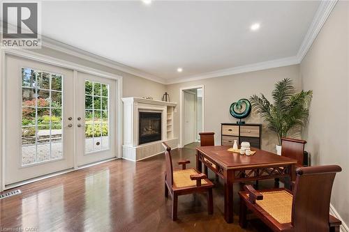 Hardwood flooring, crown molding, double French doors, built-in fireplace with a mantel, and recessed lighting - 334 Coleridge Drive, Waterloo, ON 