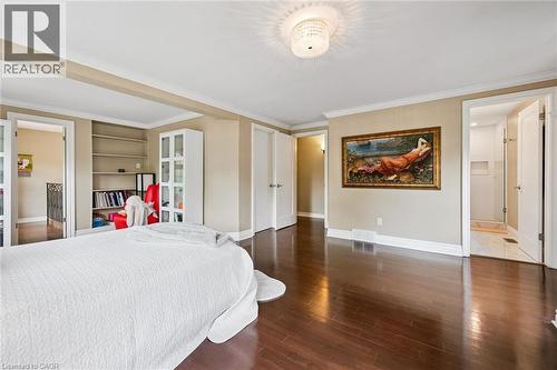 Hardwood flooring, recessed built-in shelving, crown molding, double doors, and a ceiling-mounted light fixture - 334 Coleridge Drive, Waterloo, ON 
