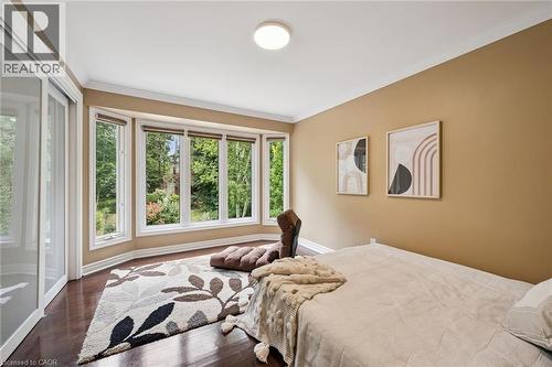 Bay window with multiple glass panes, wood-finish flooring, white crown molding, light-colored walls, and a ceiling-mounted light fixture - 334 Coleridge Drive, Waterloo, ON 