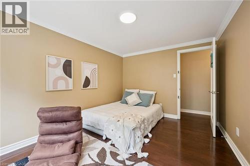 Wood-finish flooring with white trim and crown molding - 334 Coleridge Drive, Waterloo, ON 