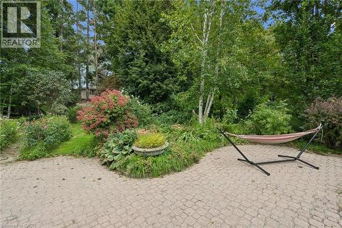 Paver patio surrounded by lush, mature landscaping - 334 Coleridge Drive, Waterloo, ON 