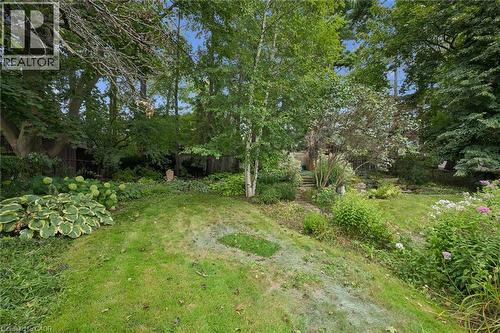 Expansive backyard featuring a green lawn, established trees, layered landscaping, and varied shrubbery - 334 Coleridge Drive, Waterloo, ON 