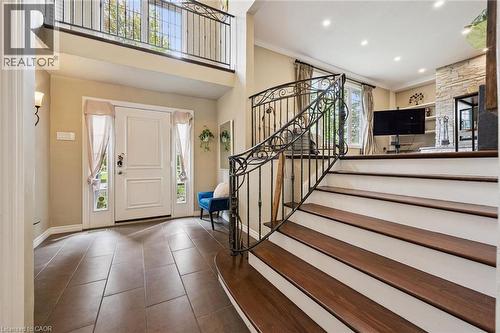 Two-story entryway featuring a decorative wrought iron staircase and a second-level balcony - 334 Coleridge Drive, Waterloo, ON 