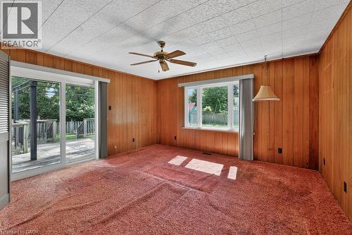 Paneling walls, ceiling fan, sliding glass door, white-framed window - 948 Long Drive, Burlington, ON 