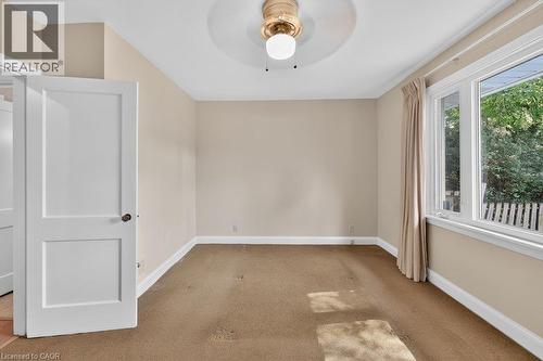 Recessed ceiling fan with light fixture, neutral wall color, white trim, and a window with a natural outdoor backdrop - 948 Long Drive, Burlington, ON 