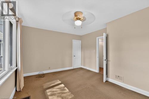 Neutral-toned walls complement the carpeted flooring - 948 Long Drive, Burlington, ON 