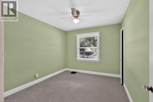 Carpeted room with a ceiling fan, white trim, and a window with blinds - 948 Long Drive, Burlington, ON 