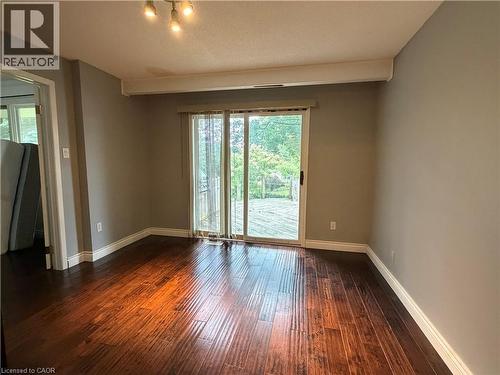 Wood-finish flooring, sliding glass door, overhead track lighting, neutral wall paint, and white trim - 450 Bridge Street W, Waterloo, ON 