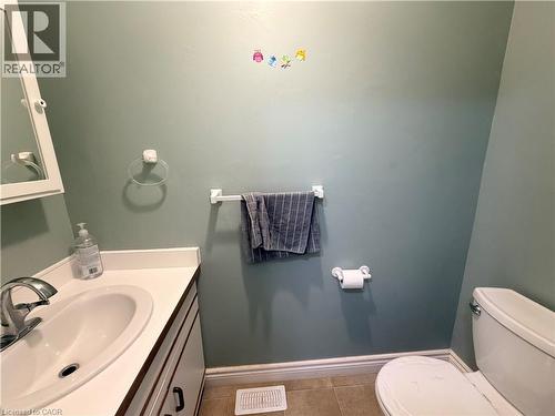 Vanity with integrated sink, chrome faucet, white cabinetry, and a wall-mounted medicine cabinet - 450 Bridge Street W, Waterloo, ON 