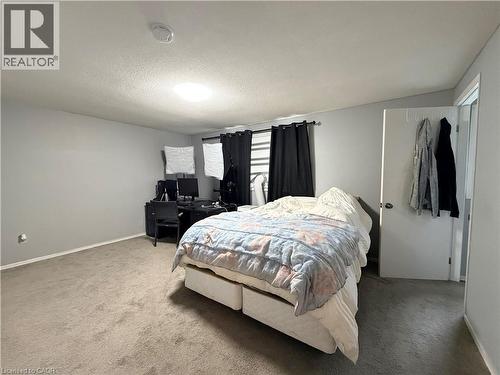 Wall-to-wall carpeting with light gray walls and white trim - 450 Bridge Street W, Waterloo, ON 