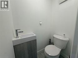 Modern vanity with an integrated basin, chrome faucet, and wood-finish cabinetry - 