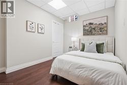 Wood-finish flooring with white baseboards and a neutral wall color - 
