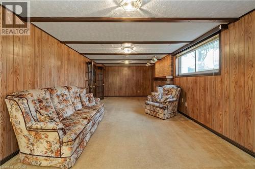 Wood-paneled walls, exposed ceiling beams, recessed lighting, and a window providing natural light - 36 Buckingham Drive, Hamilton, ON 