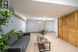 Recessed ceiling lighting, light-colored carpeting, and light wood louvered doors - 