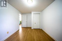 Wood-finish flooring with crisp white walls and trim - 