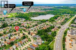 Aerial perspective showcasing a residential neighborhood with established homes, tree-lined streets, and a prominent road - 