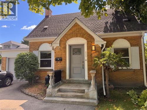Brick exterior with a gabled roof and arched entry - 225 Bridgeport Road E, Waterloo, ON 