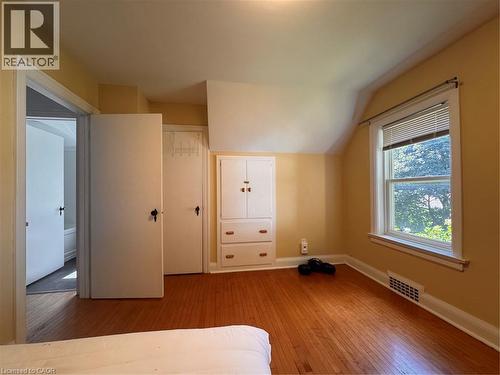Hardwood flooring, painted walls, built-in cabinetry, window with blinds, white trim - 225 Bridgeport Road E, Waterloo, ON 