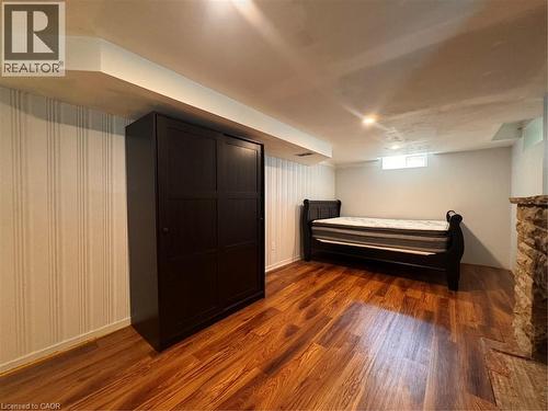 Wood-finish flooring, recessed lighting, beadboard accent wall, and stone-clad wall feature - 225 Bridgeport Road E, Waterloo, ON 