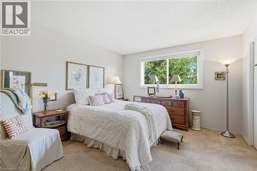 Primary bedroom with a large window, providing natural light - 89 Brigade Drive, Hamilton, ON 